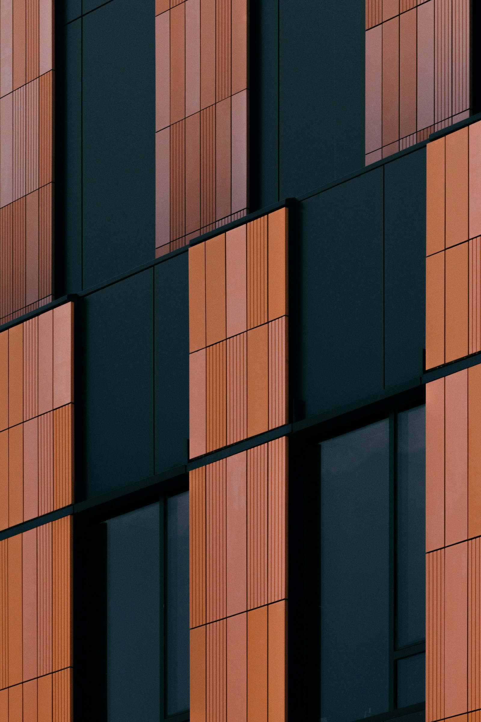 Orange architectural panels and dark windows form a distinctive repeating pattern